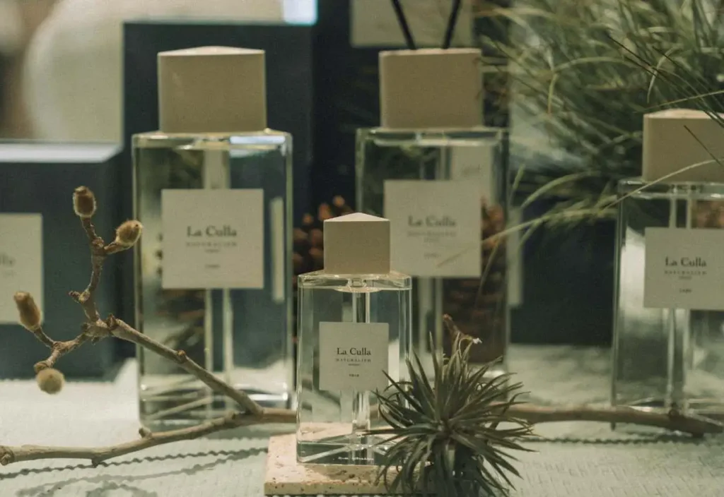 perfume bottles with herbs around them