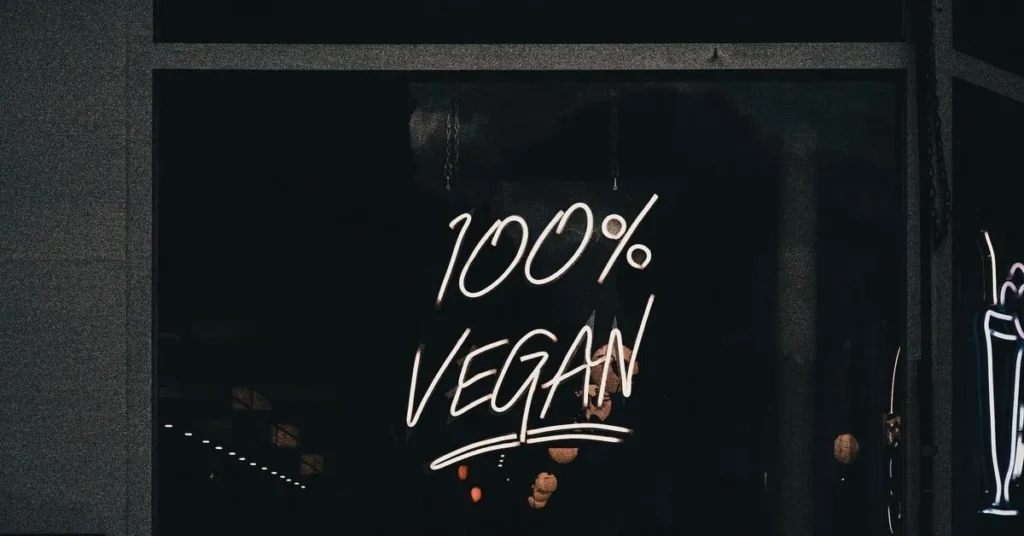 words '100% vegan' written on tinted glass